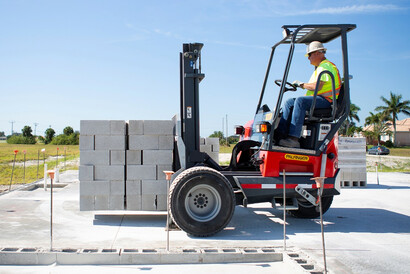 Truck-Mounted Forklift Transporting Cement Blocks