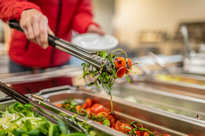 An employee takes a salad in one of our canteens.